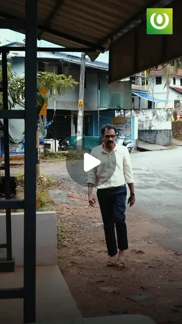 A man walking up to a village bus stop, from the Thalayatukar app video